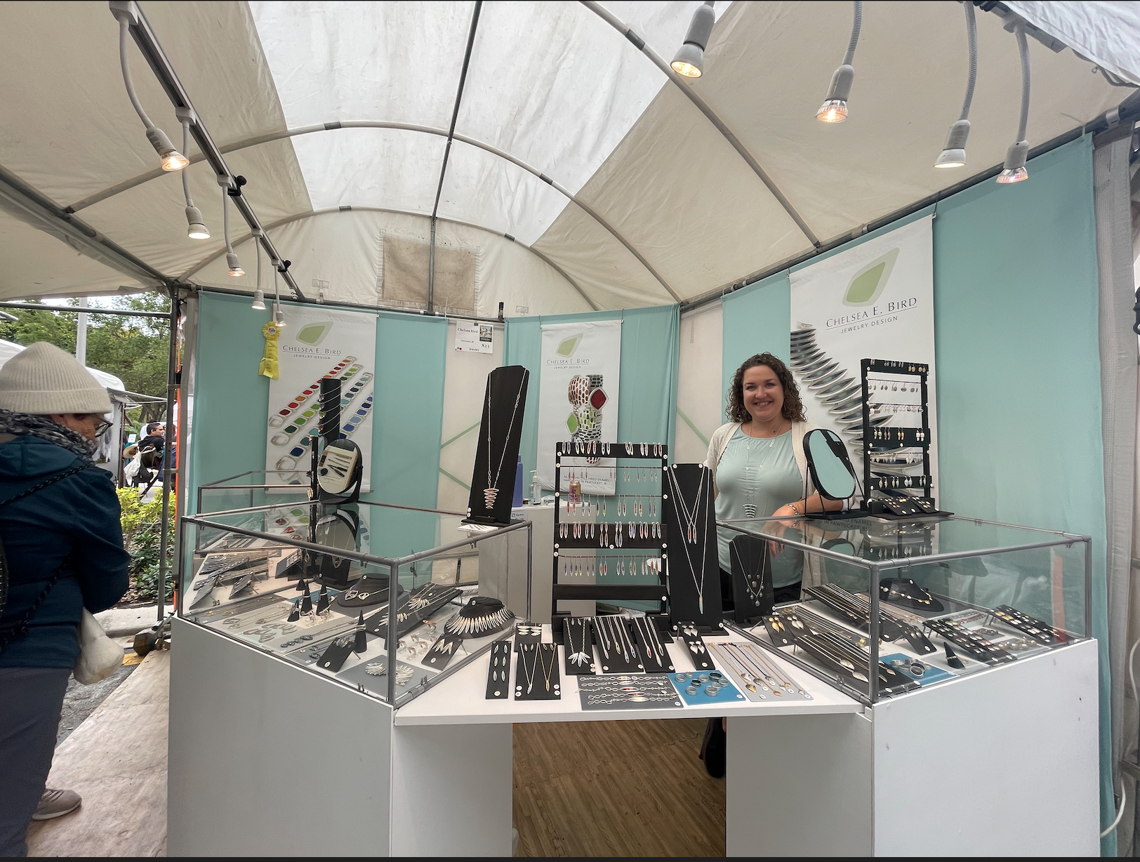 Birds jewelry stand at the Coconut Grove Art Festival displayed hand-made sterling silver and glass enamel jewelry. 